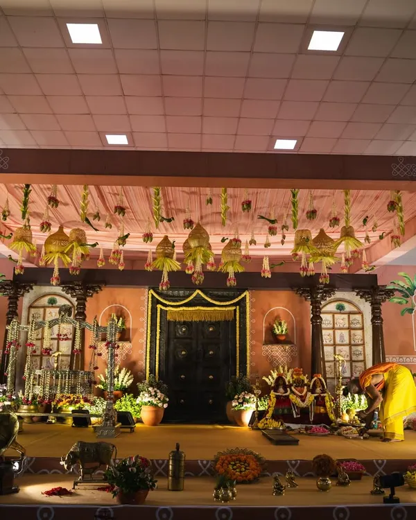 We designed this elaborate stage for little Mitharv's naming ceremony, creating a "South Indian village" theme. The decor featured a traditional door, terracotta tones, and vintage elements to bring the nostalgic concept to life.