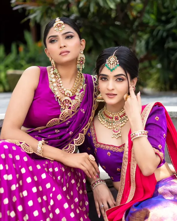 We love creating coordinated looks for bridesmaids or friends. Here, we styled two complementary half-sarees in shades of purple and pink, showcasing our custom design and group styling services.