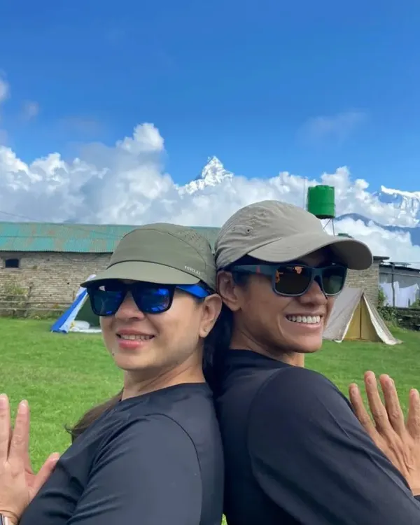 Back to back, heart to heart. Sharing a moment of connection and practice with a fellow yogi against the backdrop of the Nepal Himalayas.