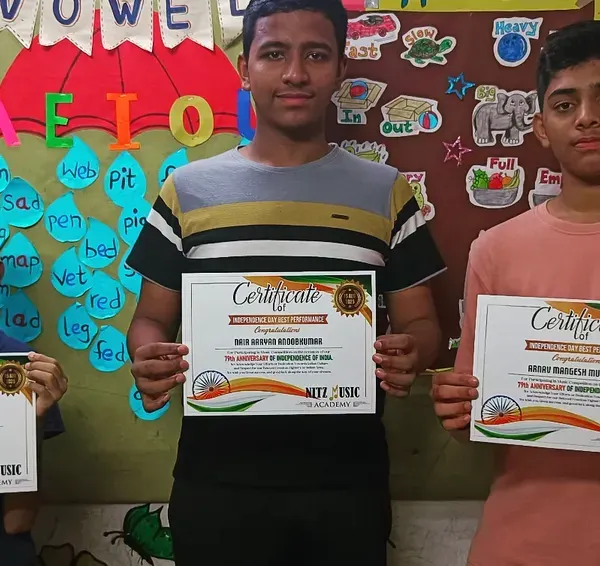 Celebrating our students' achievements. Three of our talented learners proudly holding their certificates after a successful performance.