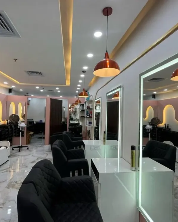 A wide view of our salon interior at the AIPL Business Club, Sector 62. We've designed the space with modern aesthetics, comfortable seating, and professional lighting to ensure a premium experience for every client.