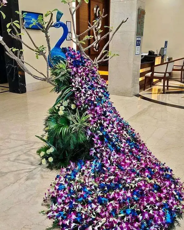 This is one of our proudest creations, a life-sized peacock sculpture made entirely of fresh purple and blue orchids. We designed this statement piece for a hotel lobby, and it shows our ability to turn a creative vision into a breathtaking reality.