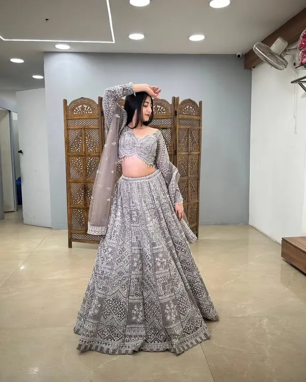 A full view of a grey lehenga with intricate white embroidery, a modern and sophisticated choice.