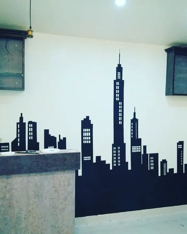 A sharp, black city skyline silhouette provides a striking contrast against a light wall. This is a popular choice for modern living areas, home offices, and commercial spaces.
