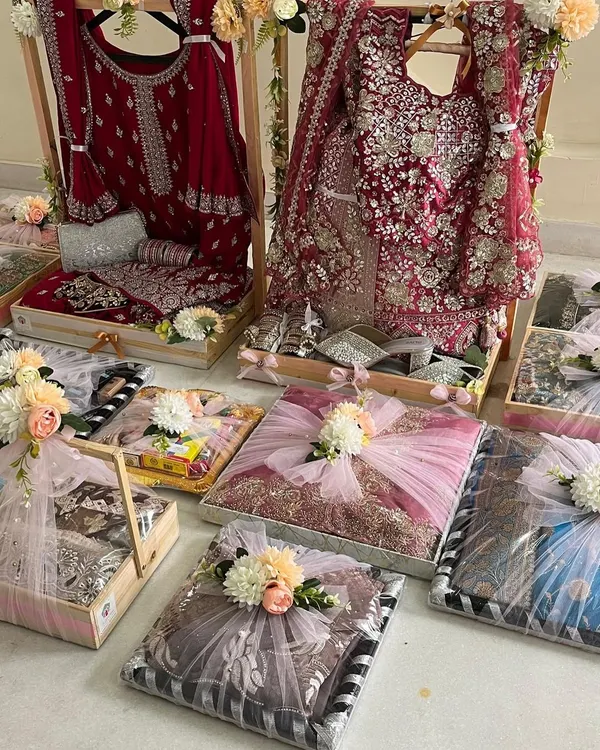 We believe in making your wedding gifting as grand as the celebration itself. Here is a glimpse of a complete trousseau setup, featuring exquisitely packed bridal wear and accompanying gifts, all designed to create a breathtaking presentation.