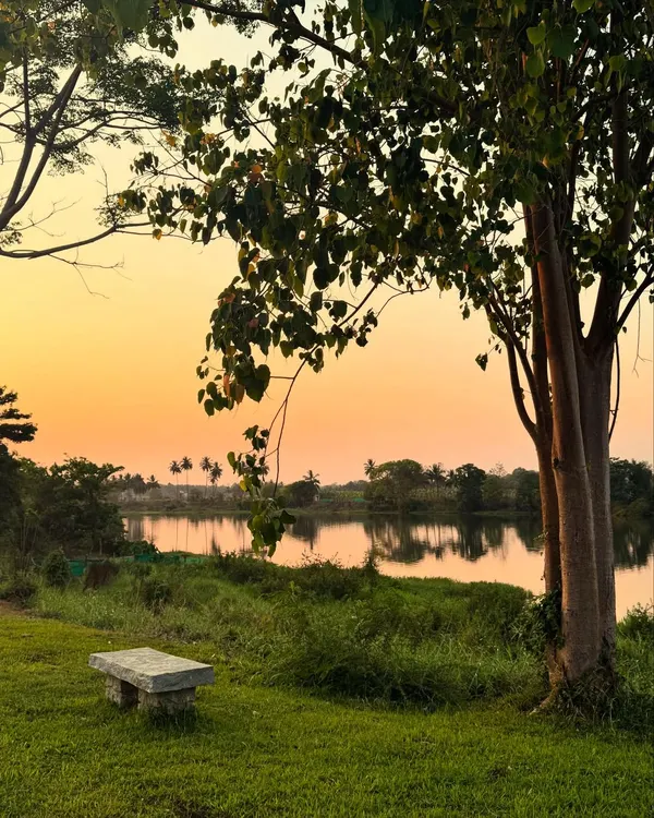 The sunset paints the sky with warmth as evening settles over the ashram. These quiet moments of reflection by the river or among the trees are a cherished part of the daily rhythm here.