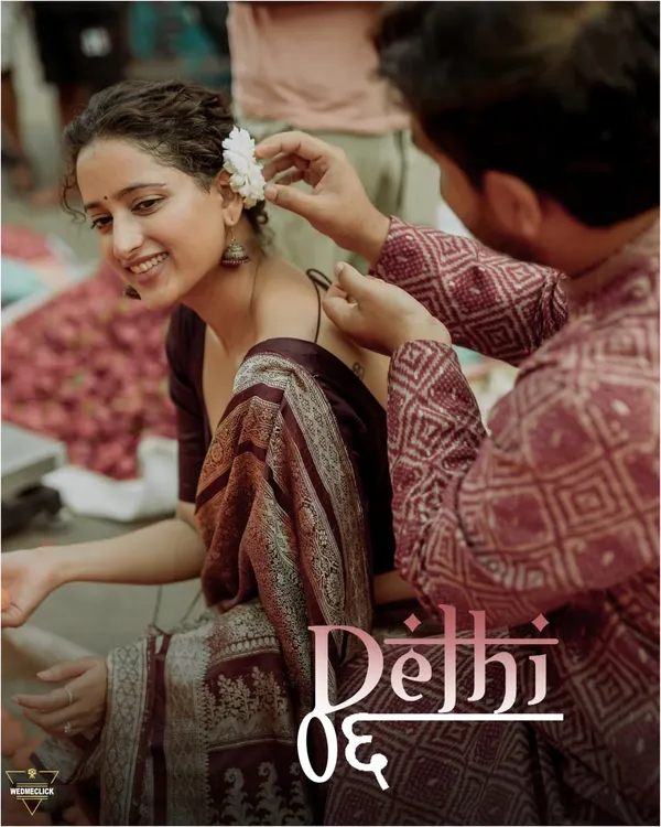 This is what a themed shoot in Old Delhi feels like. I captured this quiet, tender moment as he placed a flower in her hair, surrounded by the authentic hustle of the city. It’s these small, unscripted interactions that truly tell your story.