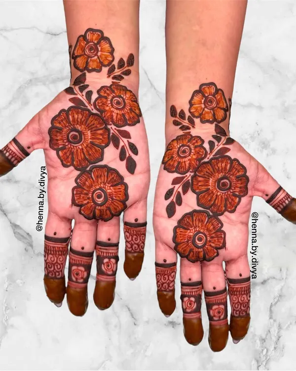 A bold and beautiful floral mehendi design. The large, shaded flowers create a dramatic and artistic look, perfect for someone who wants their henna to be the center of attention.