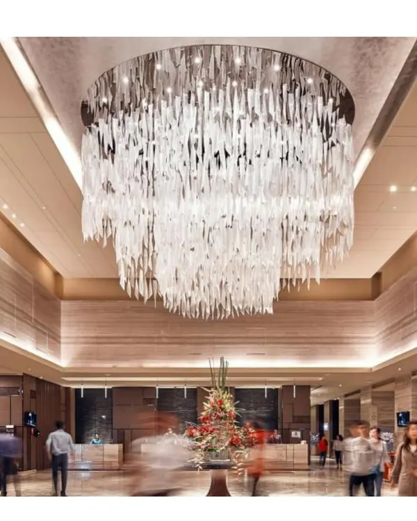 The main lobby of the Sheraton Hotel, dominated by a breathtaking custom chandelier. This feature piece was designed to create an unforgettable first impression and establish the hotel's luxurious identity.