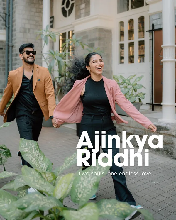 A joyful, candid shot of a couple running and laughing on a city sidewalk. This image perfectly captures the fun and energy of an urban couple shoot in Mumbai.
