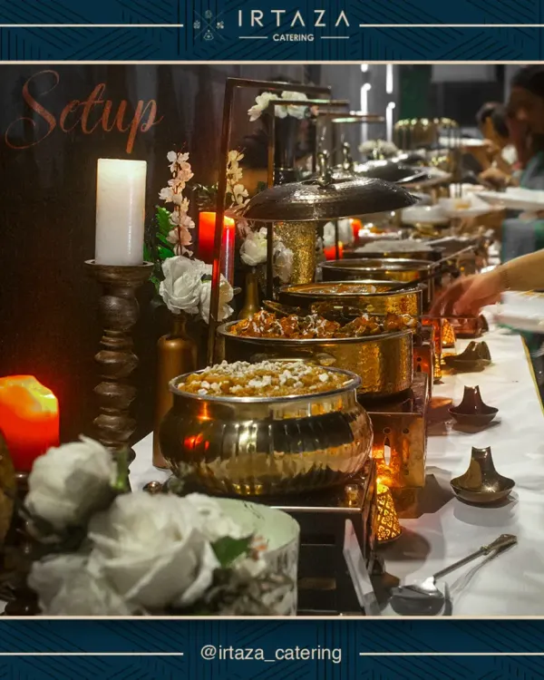 A glimpse of a full buffet setup, where golden serving dishes and warm candlelight create an inviting and luxurious atmosphere for your guests.