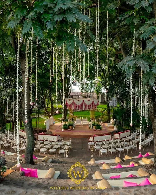 We transformed this beautiful outdoor amphitheater into a breathtaking mandap for a traditional wedding. The hanging floral tassels and elegant seating created a truly magical atmosphere for the couple's special day.