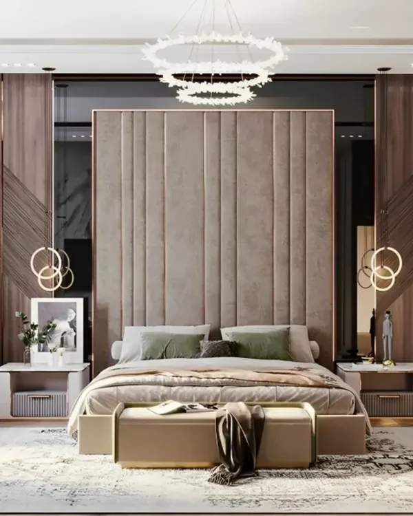 A truly grand master bedroom featuring a tall, upholstered headboard that makes a statement. I used elegant pendant lights and classic wall moulding to add a touch of timeless luxury to this residential interior design.