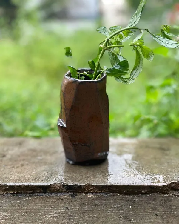 This hand-built Kurinuki vase was from a batch that failed, but its form is too beautiful not to share. The Japanese Kurinuki technique involves carving from a solid block of clay.