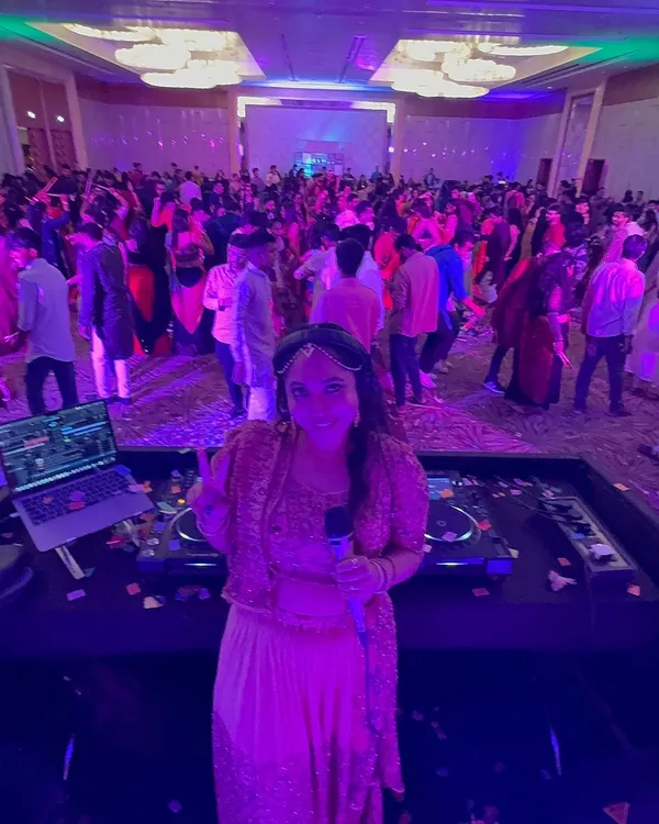 This is my view from the DJ deck, my happy place. I love looking out and seeing a massive crowd dancing and making memories at a vibrant Dandiya celebration.
