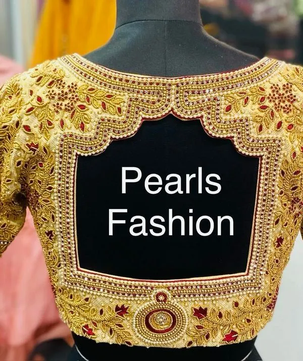 This is a custom bridal blouse with heavy Zardozi and Kundan work. I paid special attention to the sharp lines of the square back cutout and the detailed embroidery on the sleeves, ensuring a very good finish for a wedding.