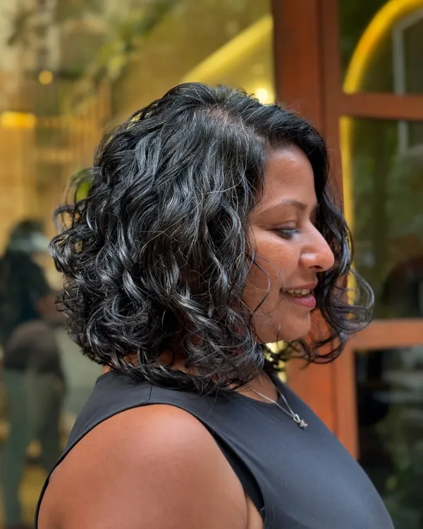 A classy curly bob is always a chic choice. This cut is perfect for giving fine or wavy hair more volume and shape.