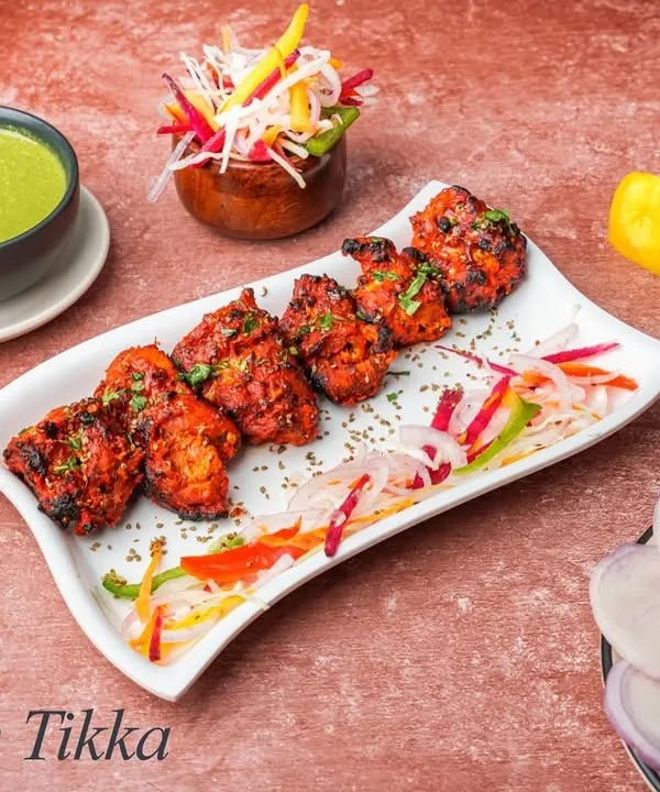 Our classic Chicken Tikka features boneless chicken pieces marinated in yogurt and spices, then grilled in the tandoor until tender and smoky. It's a timeless favourite.