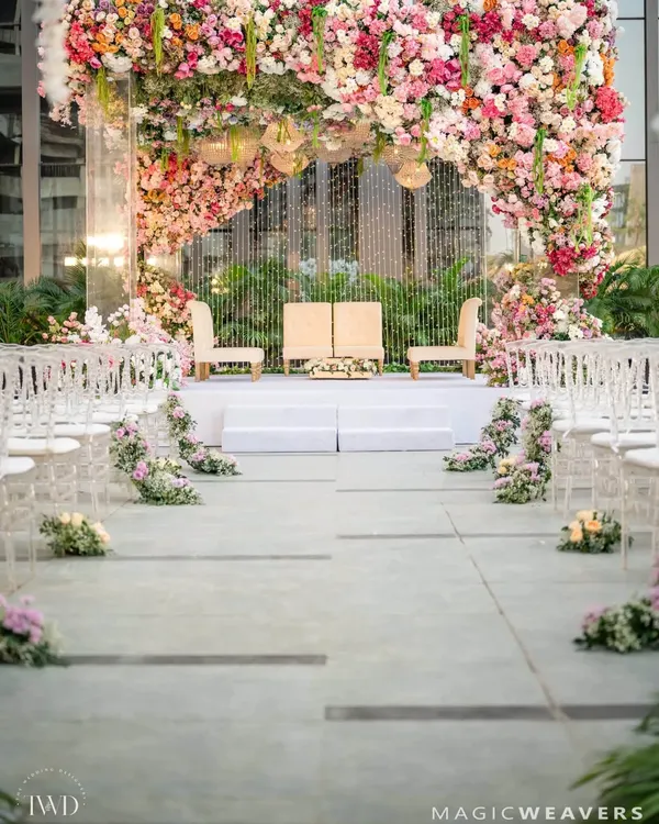 A closer look at our signature upside down garden installation. We meticulously arranged thousands of fresh flowers and elegant chandeliers to create a breathtaking canopy, making the wedding mandap feel like a scene from a dream.