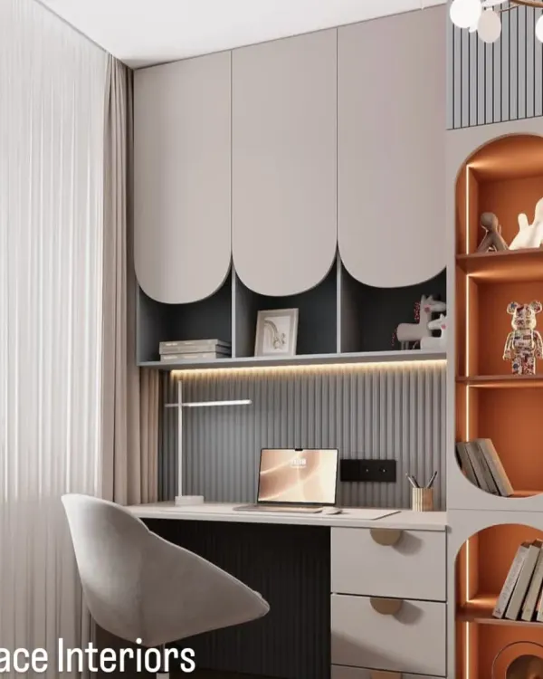 A modern and sleek study area. This design features custom overhead cabinets with curved details, built-in shelving with accent lighting, and a spacious desk, creating a sophisticated workspace.