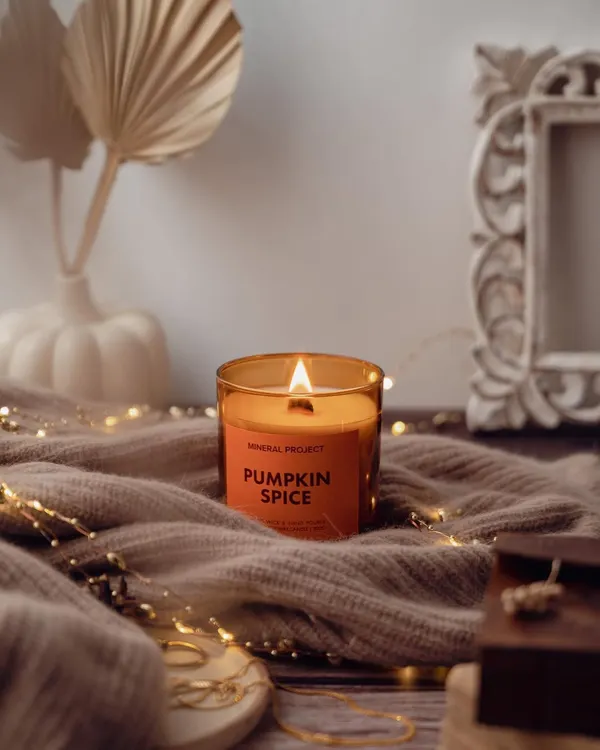 Creating a cozy autumn atmosphere for Mineral Project's Pumpkin Spice candle, using soft textiles and fairy lights to evoke warmth and comfort.
