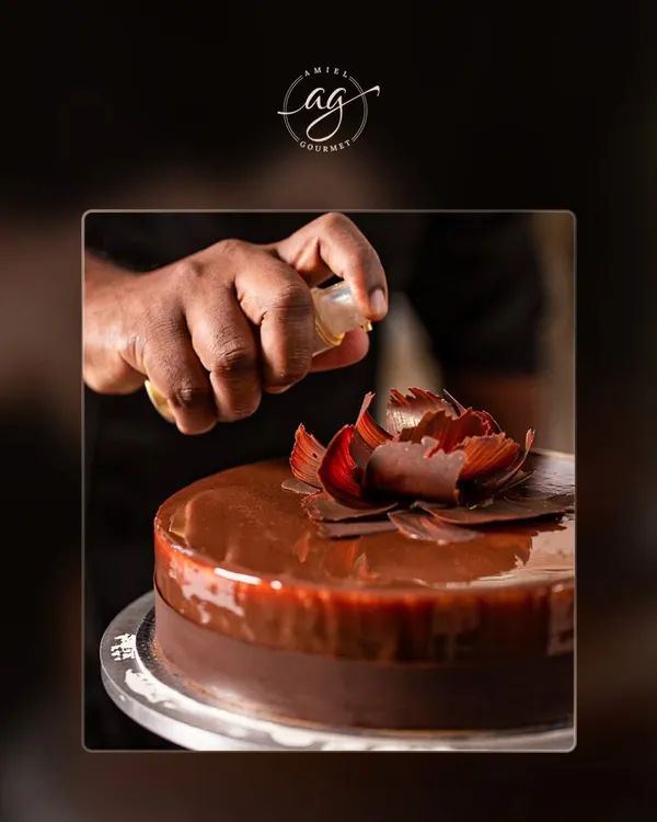 Every celebration deserves a stunning cake. Here, I am adding the final touches to a rich chocolate cake, complete with a delicate, handcrafted chocolate flower. I can customize cakes for any occasion.
