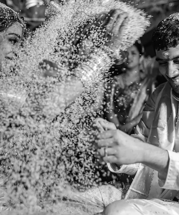 A playful moment during a South Indian wedding ritual as Sapni and Arjun shower each other with rice. We love capturing the fun and laughter that are woven into these sacred ceremonies.