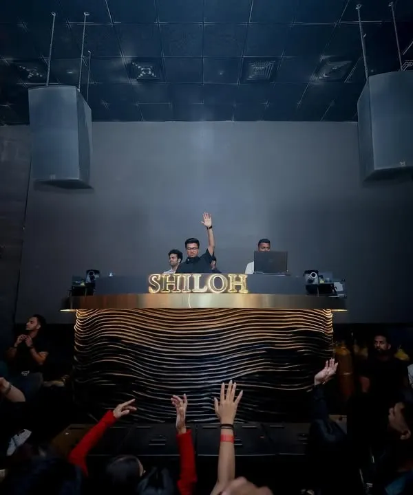 Commanding the console at Shiloh, one of Mumbai's premier clubs. A view from the dance floor as the crowd raises their hands to the beat.