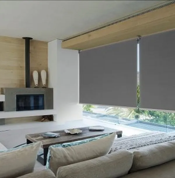 My sleek, grey roller blinds installed in a modern living room. They offer excellent light control and a minimalist aesthetic that complements contemporary furniture and open-plan layouts.