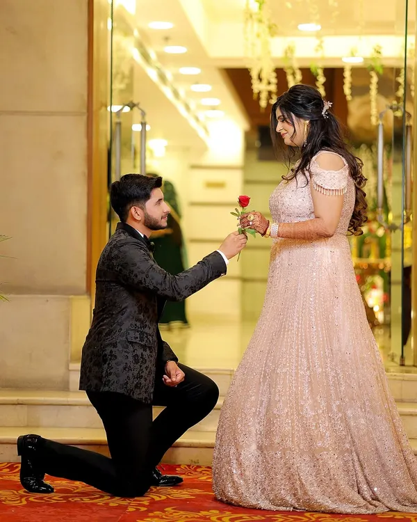 The classic proposal moment during an engagement ceremony. The groom on one knee with a rose is a timeless symbol of love that I love to capture.