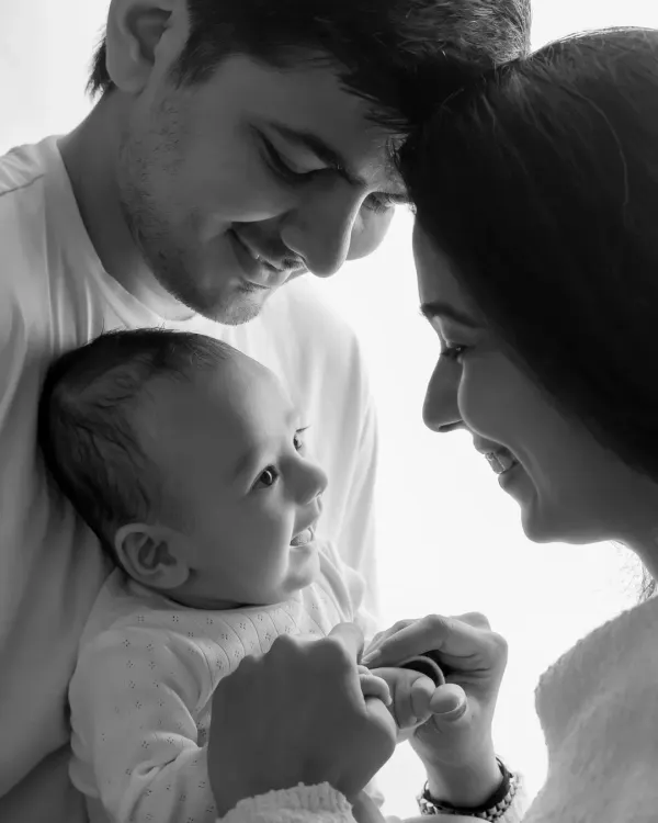 A classic black and white family photo, where the lack of color emphasizes the loving expressions and connection.