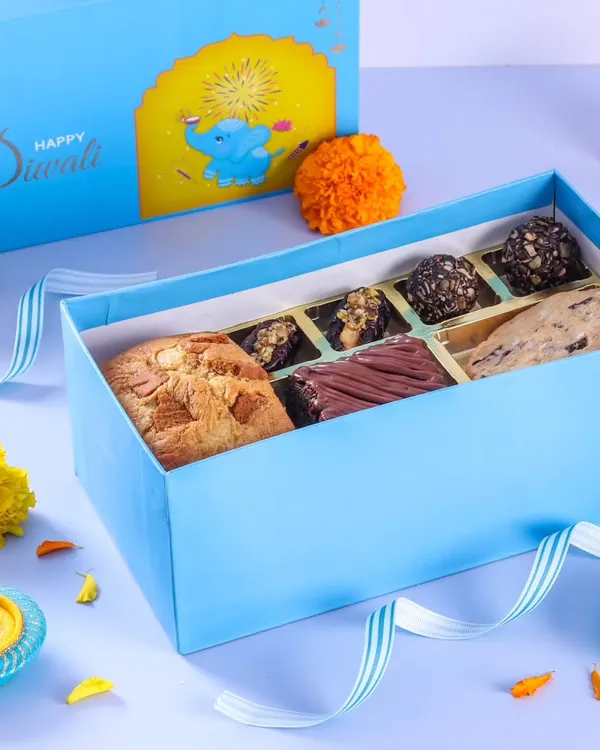A look inside one of my Diwali gift hampers, featuring a mix of big cookies, brownies, and chocolate truffles in a beautiful blue box.