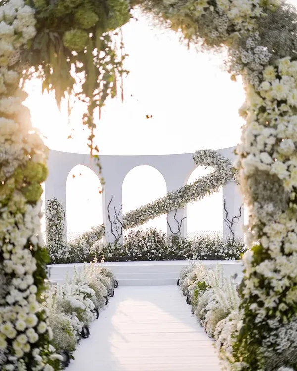 A stunning view down the aisle of an all-white wedding I designed in Goa. The floral archways frame the altar perfectly, creating a sense of heavenly grandeur for the ceremony.