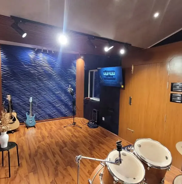 A wide view of our live room, showing the drum kit and vocal recording area. We designed it to be spacious and inspiring, a place where bands can comfortably jam and record together.
