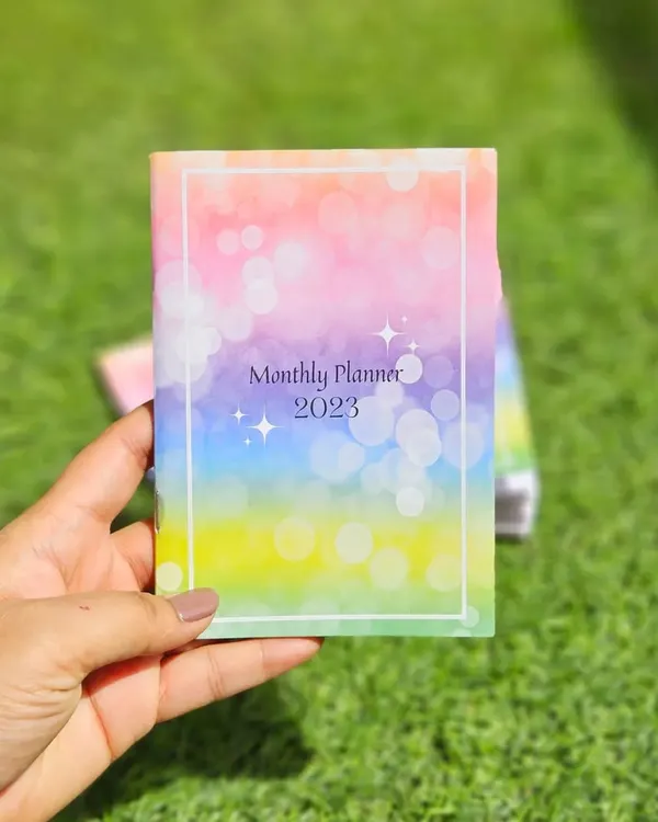 I designed this pocket sized 2023 monthly planner from scratch. The cover features a colorful bokeh design, and it's small enough to carry with you everywhere to stay organized on the go.