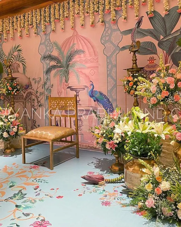 This pre-wedding celebration was a dream to design. We used a custom printed backdrop and flooring with Pichwai art, and filled the space with brass urlis, banana blossoms, and beautiful pastel florals.
