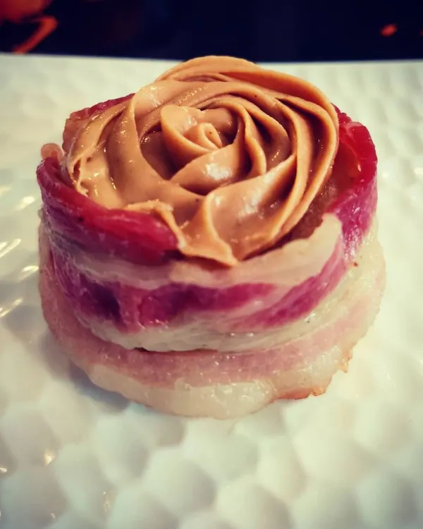 This is one of my absolute favorites to make. It's a savory keema and mixed veggie cupcake, with a surprise slice of boiled egg inside, all wrapped in bacon and topped with a peanut butter rose. It’s a gourmet dog treat that looks as good as it tastes.