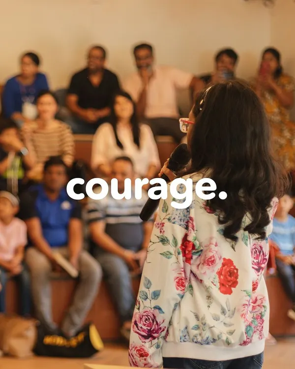 With courage, she takes the stage. Our public speaking showcases are a platform for students to share their voices with a supportive audience of family and friends.