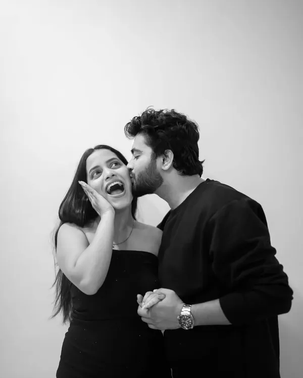 Pure, spontaneous joy. I prompted Omkar to give Riya a surprise kiss, and her reaction is priceless. Capturing these candid, happy moments in a simple black and white format makes the emotion even more powerful.