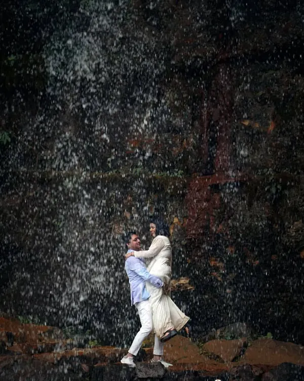 A moment of pure joy and abandon in front of a cascading waterfall. I love capturing these dynamic, high-energy shots that show a couple completely lost in the moment and in each other.