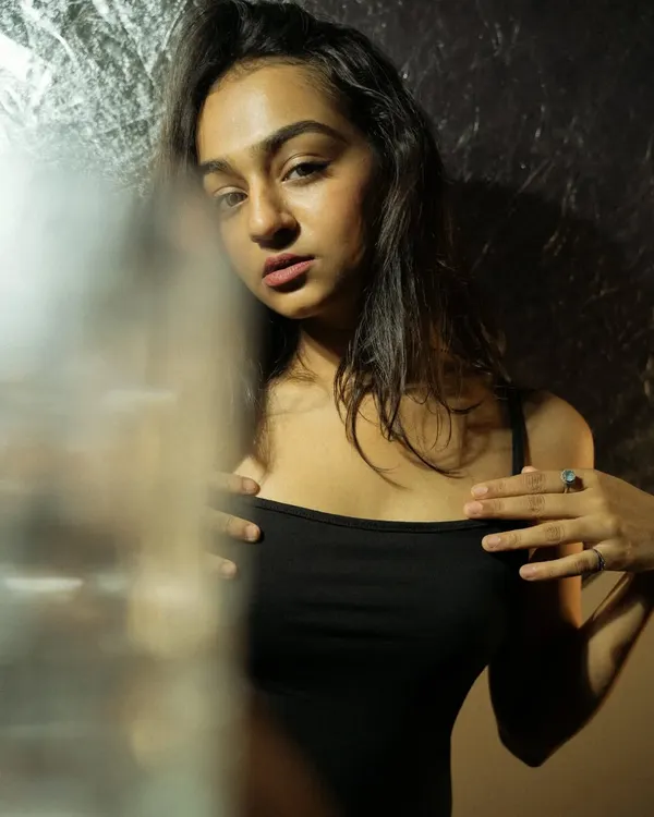For this portrait, I created a mirror-like distortion effect simply by placing a glass in front of my lens. This is a great technique for adding an abstract, reflective layer to your indoor photography.