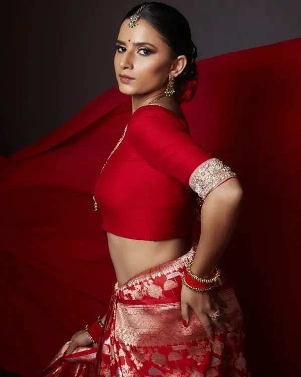 This look is my 'lal ishq', my pure passion for creating something powerful and timeless. I focused on a flawless base, dramatic smokey eyes, and a defined brow to complement the rich red Banarasi saree, creating a modern yet classic editorial statement.
