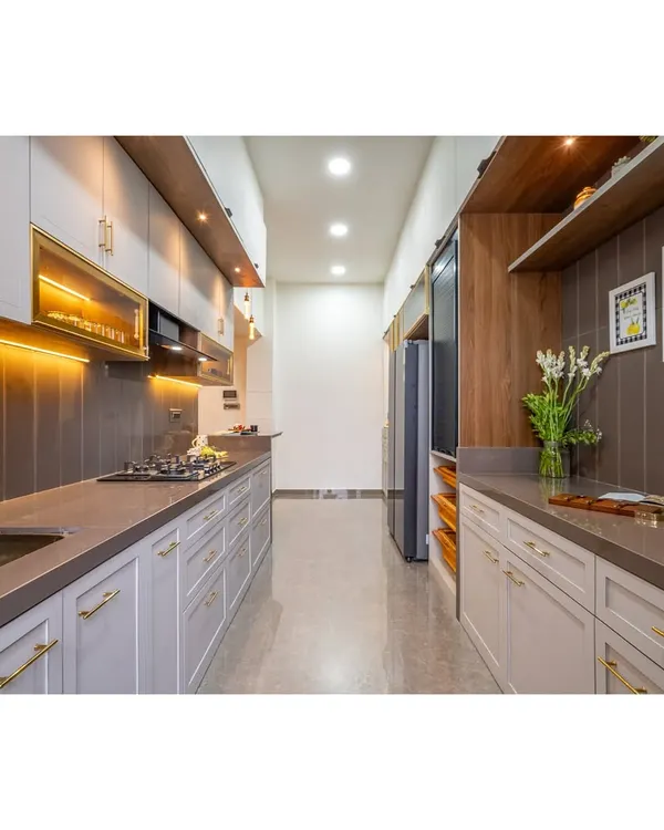 A sleek and modern parallel kitchen designed for ultimate functionality. The layout provides ample counter space and storage, with a sophisticated color palette of light grey, dark countertops, and warm wood accents.