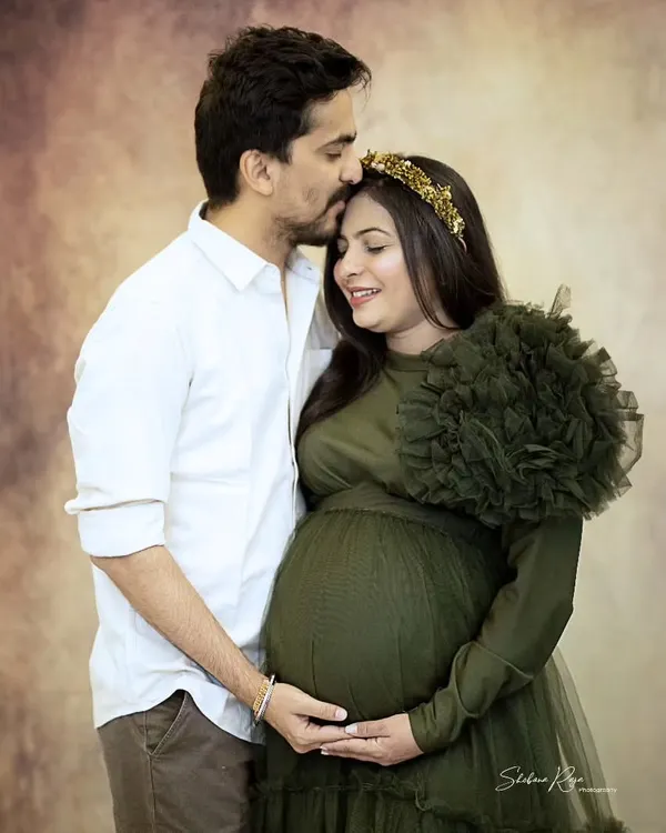 I love capturing the quiet connection between couples before their new journey begins. This tender moment, with a gentle forehead kiss, shows the love and anticipation that fills the air during a couple's maternity shoot.