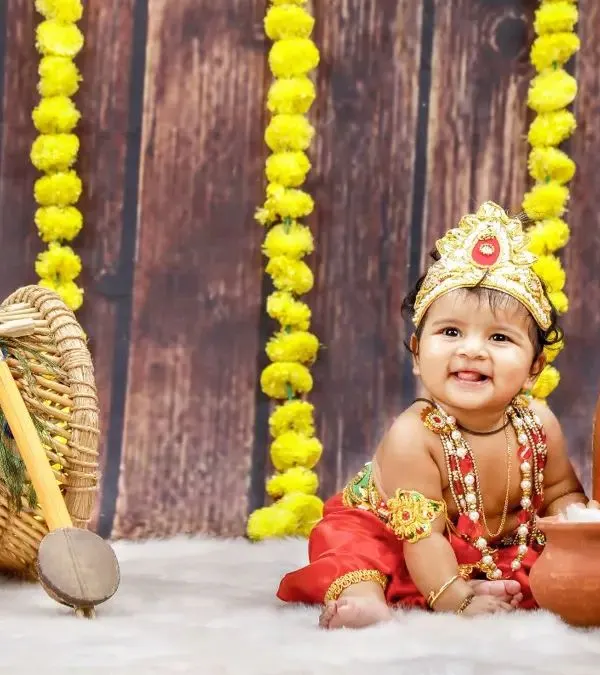 Celebrating Krishna Jayanthi with our adorable little Krishna! This setup features clay pots, marigold flowers, and a beautiful smile that could steal anyone's heart.