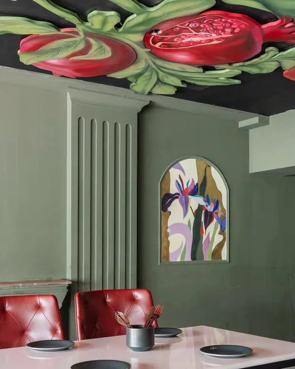 Inspired by Michelangelo, but with a juicy twist. This modern-day fresco of pomegranates and lilies on the ceiling brings drama and a sense of abundance to the dining space.