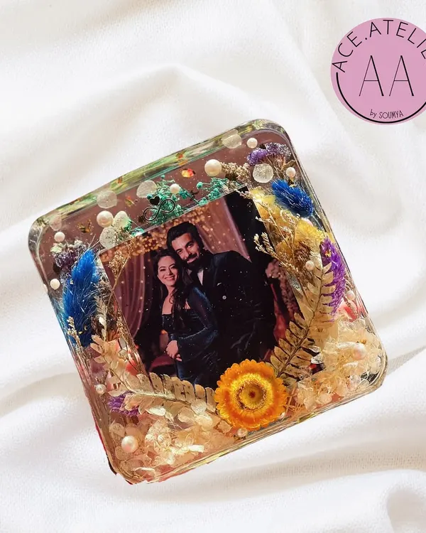 A beautiful deep-cast resin photo frame, filled with a variety of preserved flowers and botanicals. This freestanding block makes a wonderful personalized gift for any occasion.