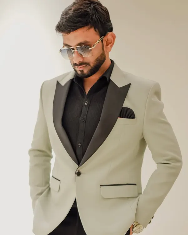 Sporting a stylish light green tuxedo with a black satin lapel. My wardrobe is carefully selected to match the sophistication of high-end events, from weddings to corporate galas.