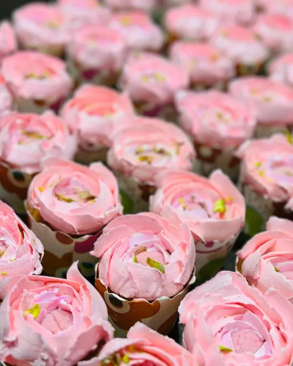 My signature Rose Rasmalai cupcakes are a fusion favorite. These went out in bulk for a kitty party, and each one is frosted to look like a delicate pink rose.