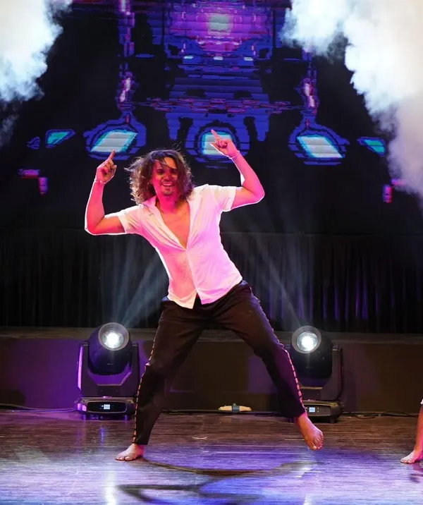 This is what it's all about. The lights, the energy, the stage. Here I am during my self-choreographed showstopper performance at our annual Zest showcase, where every student gets their chance to shine.